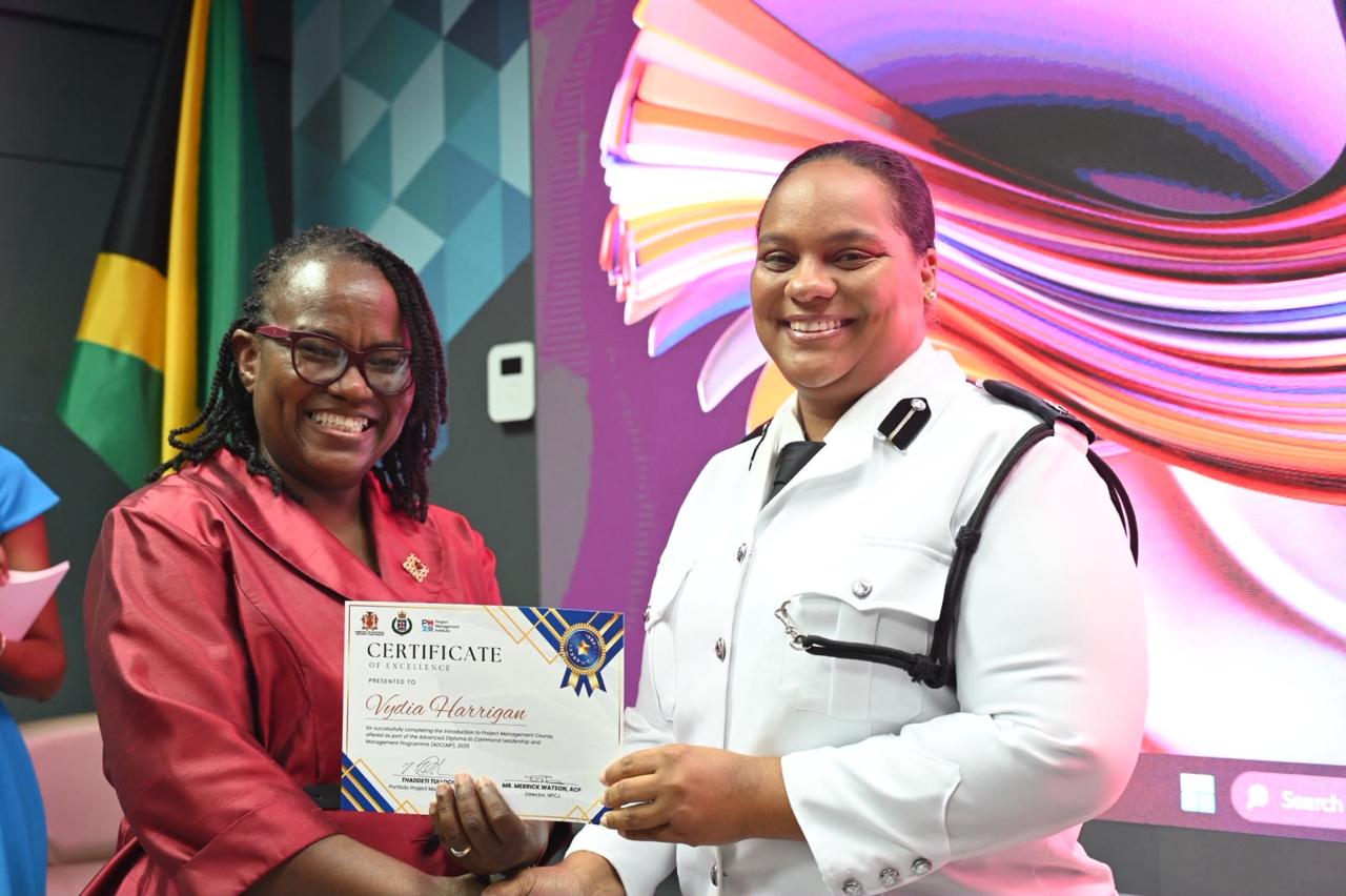 Graduates proudly display their certificates of excellence at the Project Management Graduation Ceremony at the offices of the Ministry of National Security and Peace on September 3.